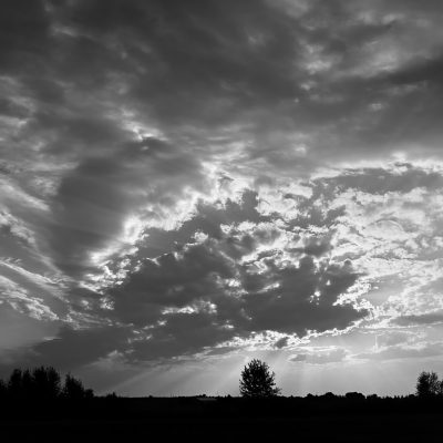 A skylife with the sun behind clouds and crepuscular rays over the Strathmore, AB.#
